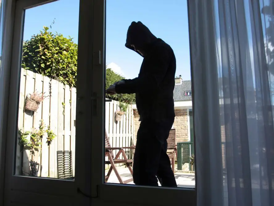 a burglar trying to break in through a patio door